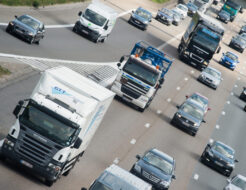 Busses, commercial vehicles, vans and lorries driving on a motorway