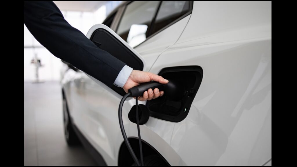 Business,Professional,Displaying,Electric,Car,At,Vehicle,Dealership.,Hand,Connecting